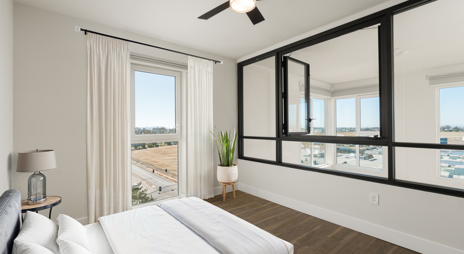 Bedroom with windows overlook living aread
