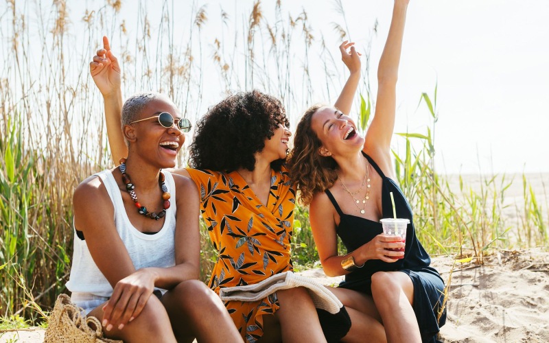 a group of people sitting on a beach